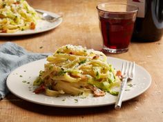 a white plate topped with pasta and broccoli