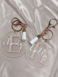 two personalized acrylic key chains with tassels