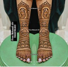 the legs and feet of a woman with henna tattoos