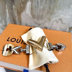 Authentic Louis Vuitton Two Tone V Bracelet Gold And Silver Tone Metal Lv Logo Engravings Good Condition, Does Have Scratches Throughout Bracelet And Inside Shows Discolor As Photoed. Not Noticed When Wearing Comes With Duster Only V Bracelet, Lv Logo, Chunky Bracelet, Chunky Bracelets, Bracelet Gold, Gold And Silver