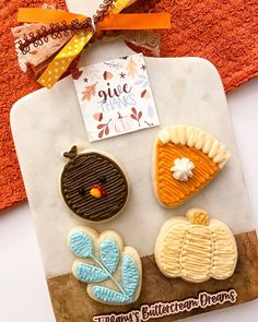 three decorated cookies are on a tray