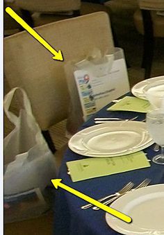 the table is set with white plates and silverware, which are marked in yellow