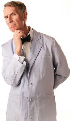 a man in a suit and bow tie posing for the camera with his hand on his chin