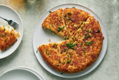 a cheese pizza on a white plate with a slice cut out and served next to it