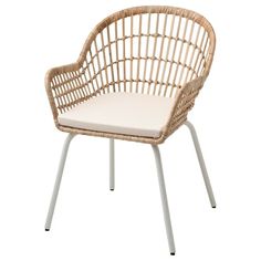 a wicker chair with a white cushion on the back and legs, sitting against a white background