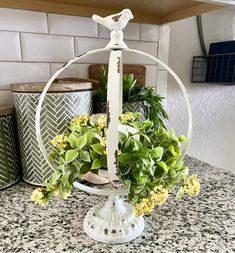 a vase filled with flowers sitting on top of a counter