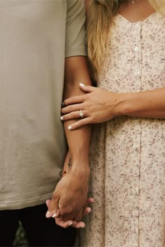 a close up of two people with their hands on each other's chests