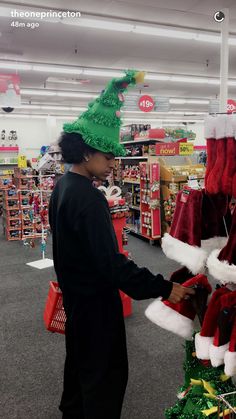 a woman is shopping for christmas hats at the store