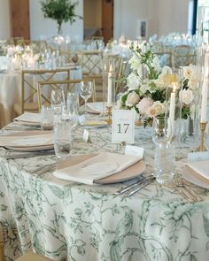 the table is set with white flowers and silverware for an elegant wedding reception or special event