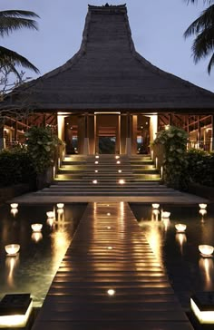 the entrance to a resort with candles lit up