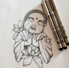 a drawing of a buddha sitting on top of a table next to two markers and a pen