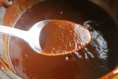 a spoon full of sauce in a pot