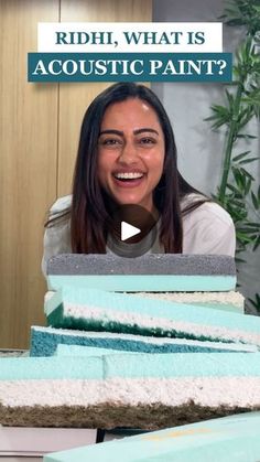 a woman sitting in front of a pile of blue and white sponges with the words, what is acoustic paint?