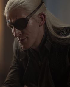 a man with long white hair wearing sunglasses