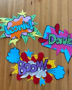 three different types of comic bookmarks on a wooden surface with the word boom written in bold colors