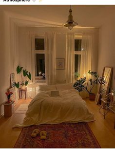 a bed room with a neatly made bed and lots of plants on the windowsill