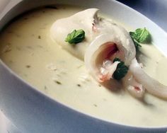 a white bowl filled with soup on top of a table