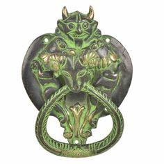 an ornate green door knock with two lions on it's face and the letter o