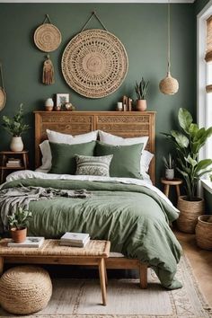 a bed with green sheets and pillows in a bedroom next to potted plants on the wall