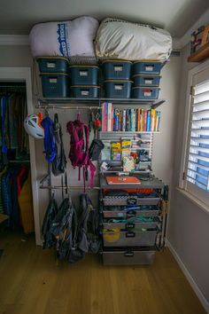 an organized closet with clothes and other items