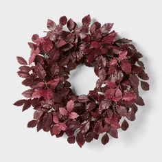 a wreath with red leaves hanging from it