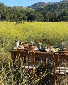 an old table is set up in the middle of a field