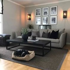 a living room filled with furniture and pictures on the wall above it's coffee table