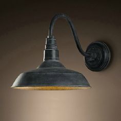 an industrial style wall light with a metal shade