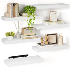 three white shelves with plants and books on them