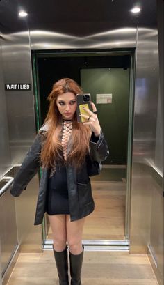 a woman taking a selfie in an elevator