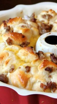 a casserole dish with sausage and cheese in it, ready to be eaten