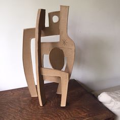 a wooden sculpture sitting on top of a table