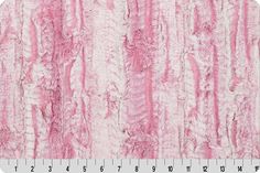 a pink and white fur textured fabric with lines in the center, on a ruler