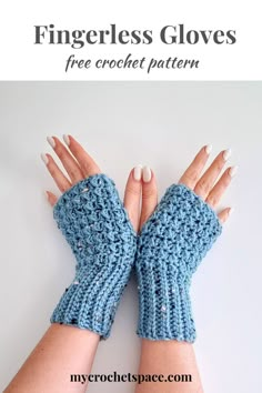 the fingerless gloves are knitted in blue yarn and have crochet detailing