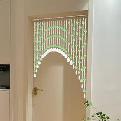 the door is decorated with green and white beads