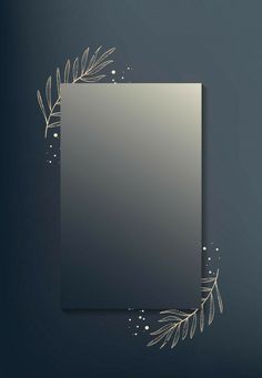 a square mirror with gold leaves and branches around it on a dark blue wall background