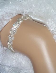 Garter, Weddings, Wedding Garter, Bridal Garter, Bridal, Rhinestone Garter, Crystal Garter, Garder, Wedding Garder,  Bling Garter Rhinestone trim bridal keepsake garter is encrusted with clear Czech crystals. in a unique and regal pattern. Rhinestone crystal and beaded trim is .75" wide and is a unique pattern of rhinestone twists and diamond shape. The crystals are accented with silver beads and the sparkling effect is breathtaking, especially when the light hits it The back is secured with a couple of inches of satin and cotton stretch elastic, so it should fit comfortably while staying in place on your special day. Please send me your thigh size approximately 6 inches above the knee. These are made to order The one pictured fits size 18 to 21 inches. This garter is also available as a s Silver Fitted Bridal Accessories, Adjustable Rhinestone Bridal Accessories, Adjustable Bridal Accessories With Rhinestones, Elegant Bedazzled Bridal Belt For Wedding, Fitted Rhinestone Bridal Accessories For Party, Fitted Bridal Accessories With Rhinestones For Party, Elegant Silver Bedazzled Bridal Accessories, Elegant Bedazzled Silver Bridal Accessories, Sparkling Diamond White Wedding Dress