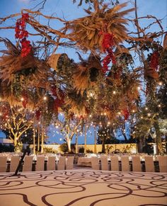 an outdoor dining area with tables and chairs set up for a formal function at night