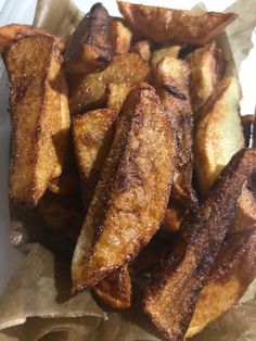 some french fries are sitting on wax paper