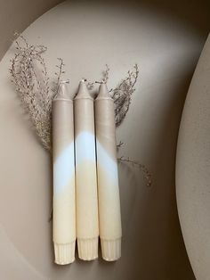 three candles sitting next to each other on a table