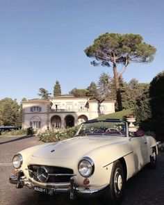 an old car parked in front of a house