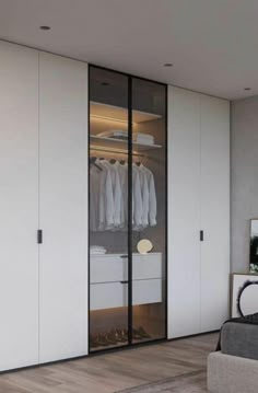 a bedroom with white closets and wooden flooring