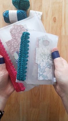 two hands are holding some crafting supplies