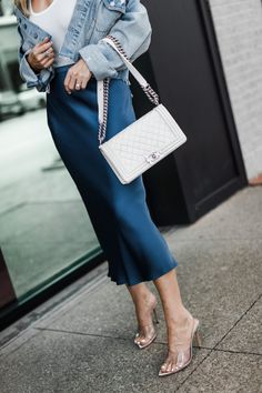 Blue Anine Bing midi skirt, Schutz heels, and a white Chanel Boy Bag White Handbag Outfit, Dress To Look Taller, White Bag Outfit, Blue Bag Outfit, White Chanel Bag, Schutz Heels, Chanel Bag Outfit, Most Expensive Handbags