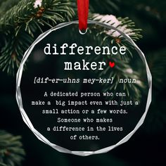 a glass ornament hanging from a christmas tree with the words, difference maker