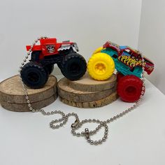 a toy truck is sitting on top of a tree stump with a chain attached to it