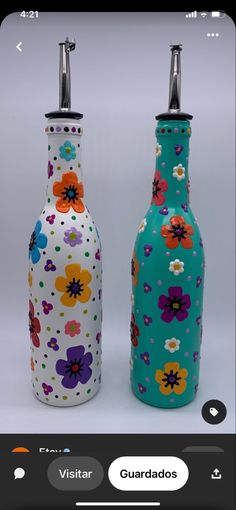 two colorful vases with flowers painted on them