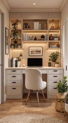 a home office with built - in shelving and desk