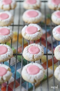 pink and white cookies cooling on a rack