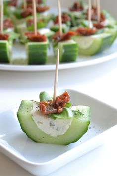 cucumber bites with toothpicks and bacon on them